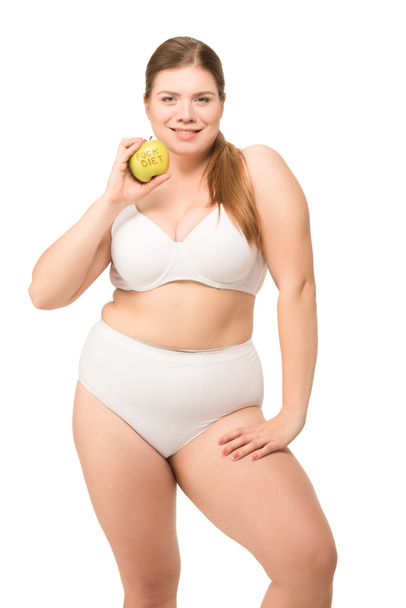 Fat smiling woman with apple - Foto, afbeelding