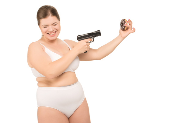 femme en surpoids avec pistolet et beignet
 - Photo, image