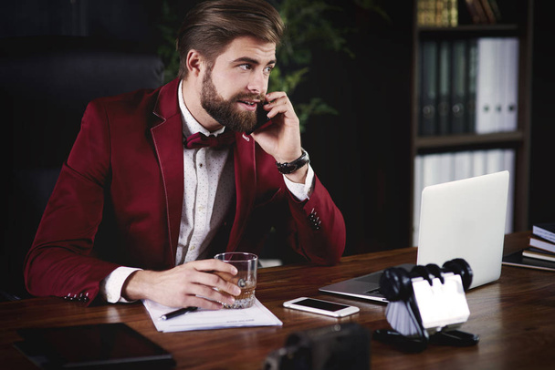Businessman talking by phone in his office  - Фото, зображення
