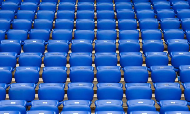 Rows of blue plastic armchairs on a tribune of stadium. - Photo, Image