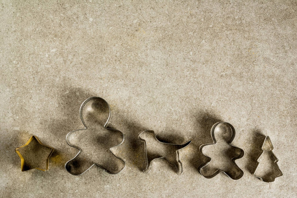 Christmas cookie cutters on gray kitchen stone table - christmas - Fotografie, Obrázek
