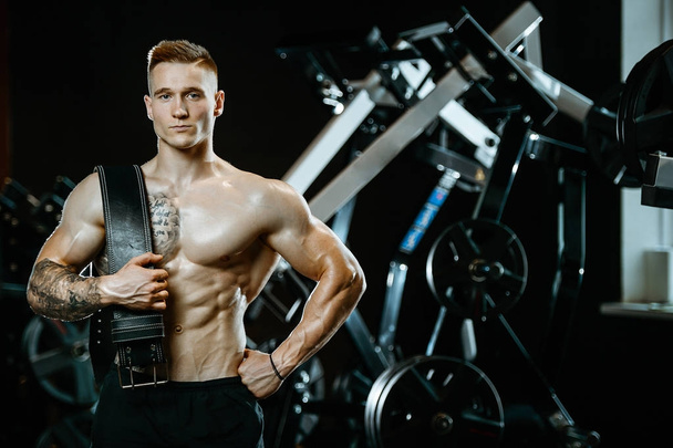 Handsome model young man working out in gym - Photo, Image