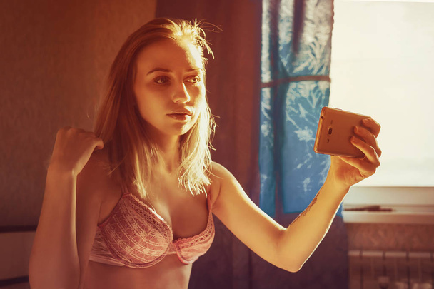 Το ήμισυ γυμνή κοπέλα φωτογραφίζεται οι ίδιοι στο τηλέφωνο - Φωτογραφία, εικόνα