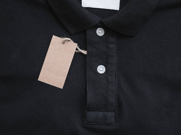 price tag hang over black t-shirt. - Photo, Image