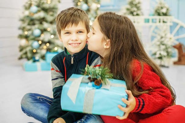 Little sister kisses brother. The boy and the girl. Happy Christ - Фото, изображение