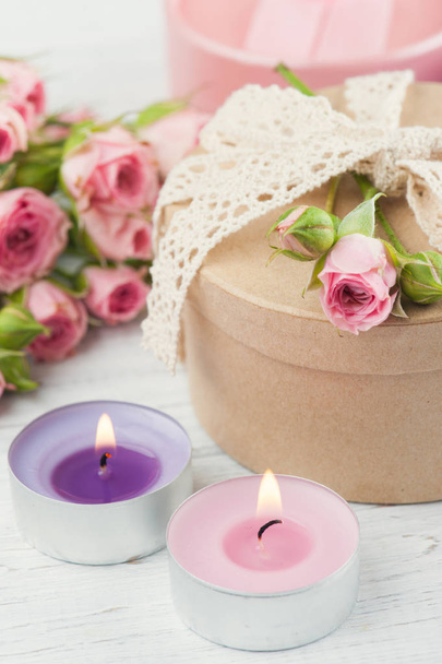 Pink roses with gift box and candle - 写真・画像