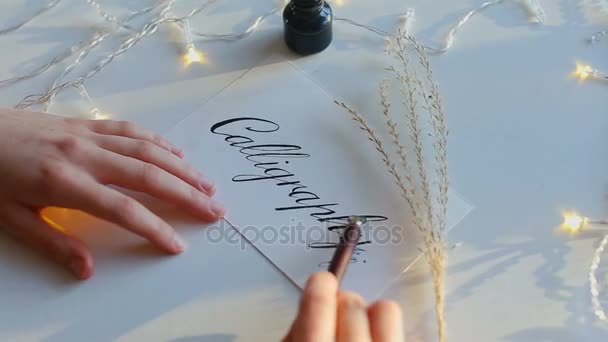 Drawn calligraphy on white paper with nib pen. - Footage, Video
