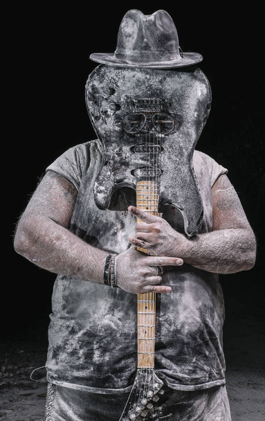 man with the guitar between chalk dust and smoke - Foto, afbeelding