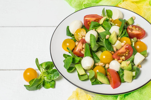 Fresh salad with mozzarella, tomatoes, avocado and lettuce  - Photo, Image