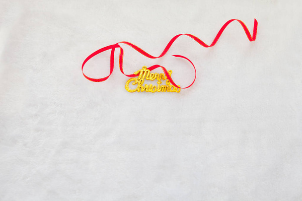 small red gift box and gold merry christmas text with red ribbon - Photo, Image