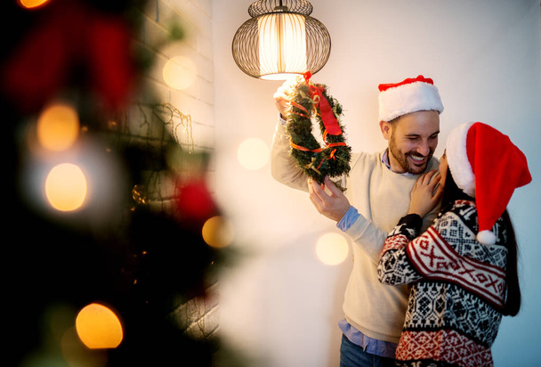 couple decorating home for Christmas  - Photo, Image