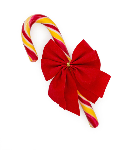Christmas candy cane with red bow isolated on white background,  - Foto, Imagen