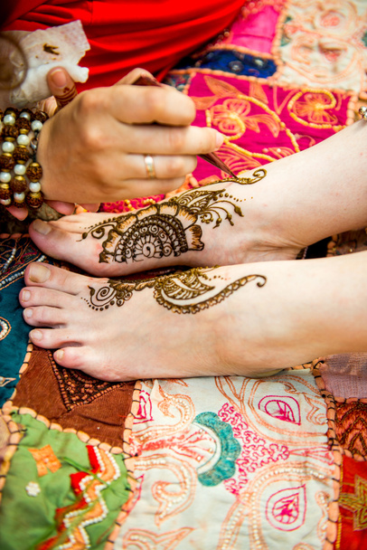 Picture of human hand being decorated with henna tattoo, mehendi - Foto, imagen
