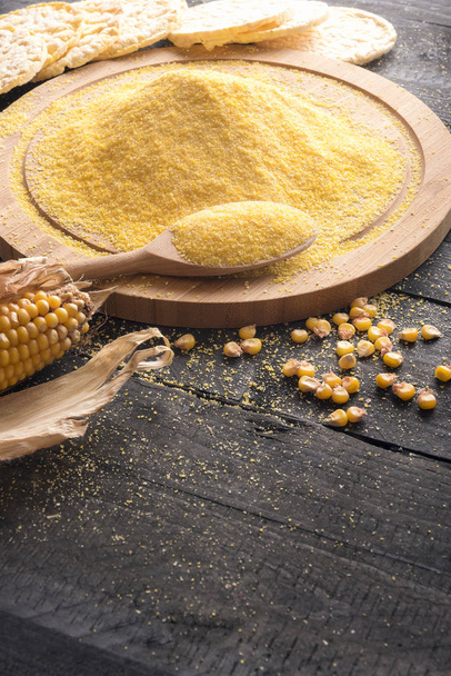 Corn flour on wooden board and grains - Photo, Image