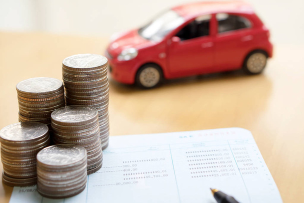 Coins stack in columns, saving book, car. Finance and banking co - Zdjęcie, obraz