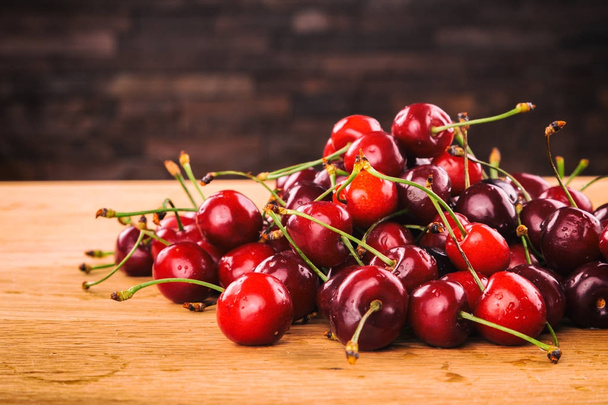 Cherries on a wooden background - Photo, Image