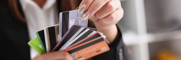 Female arm hold bunch of credit cards - Фото, изображение
