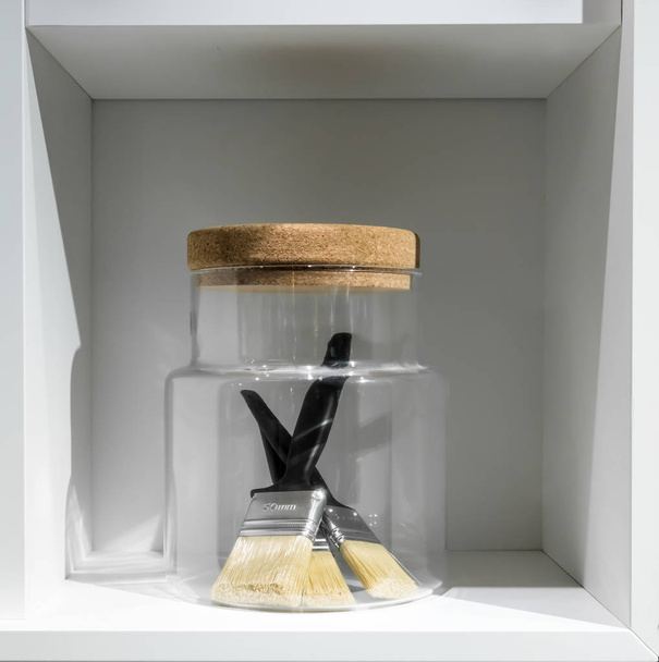 Paint brushes in glass container with cork lid.  - Fotografie, Obrázek