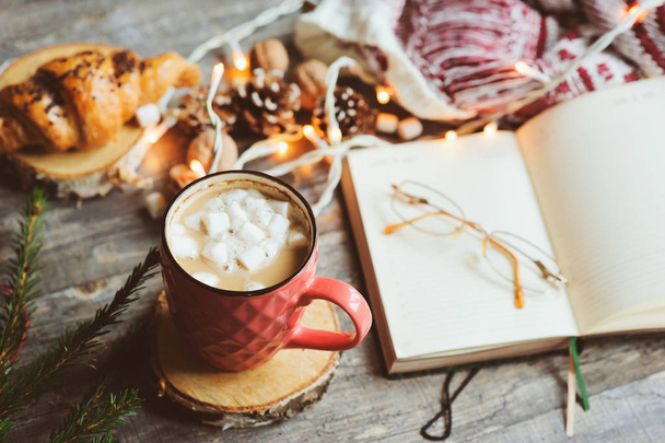 weekly planner or to do list top view with Christmas decorations and hot cocoa. Choosing gifts and planning holidays concept - Fotó, kép