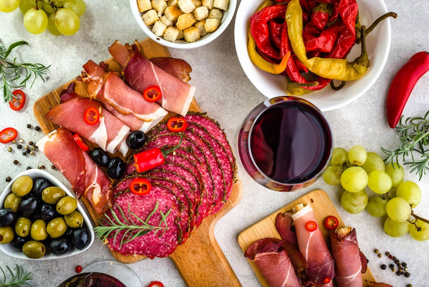 Restaurant with spanish table, food, wine and tapas, meat slices and vegetables, traditional appetizers from spain, flatlay, overhead - Foto, Imagen