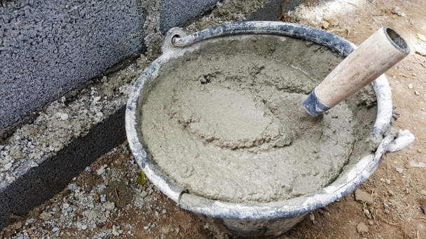 lay bricks with cement mixing tub, mortar concrete - Photo, Image