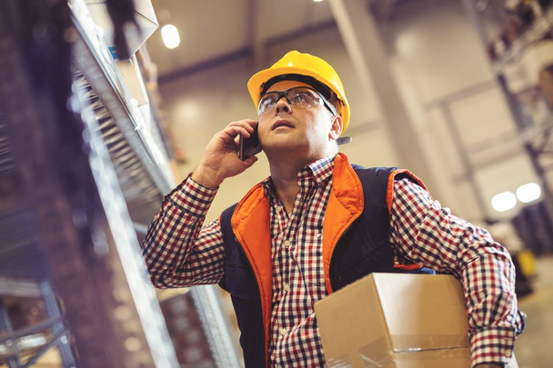 Warehouse worker talking on the phone - Photo, Image