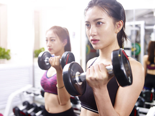 young asian woman exercising working out in gym - Photo, Image
