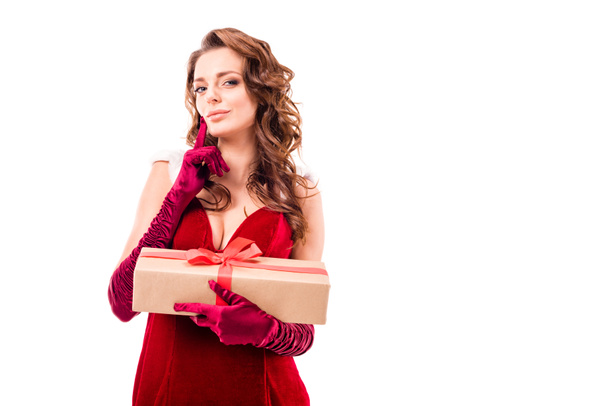pensive girl in santa costume with gift - Фото, изображение