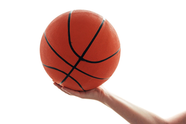 Női kéz kosárlabda labda elszigetelt fehér background - Fotó, kép