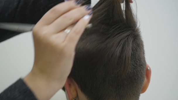 The womans hairdresser makes styling her hair on short hair - Footage, Video