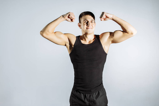 Cheerful muscular guy posing in front of the camera. - Fotografie, Obrázek