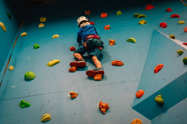 little boy climbing wall in sport center - Photo, Image