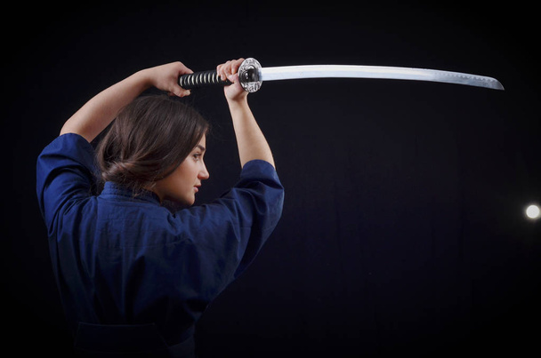 brunette girl in a kimono holding a sword - Zdjęcie, obraz