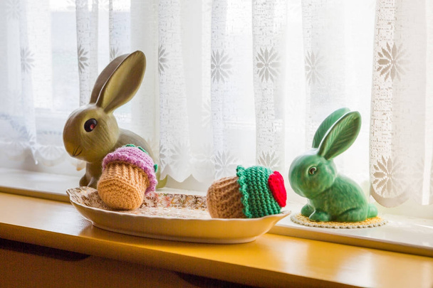 Cute cotton bunnies standing by the window - Foto, Imagem