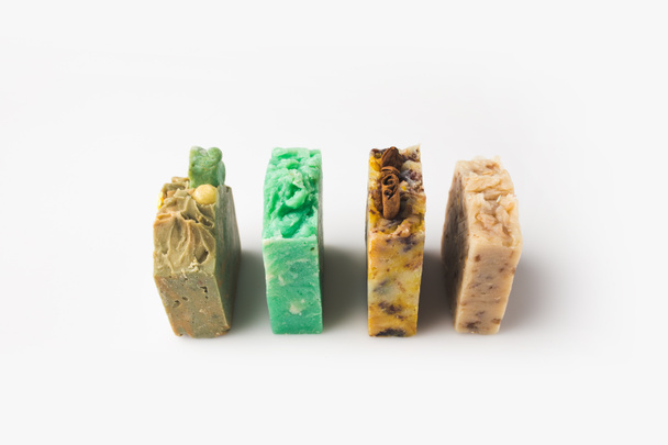 handcrafted soap standing in row - Фото, зображення