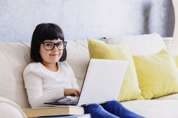 Kleines Mädchen in lässiger Kleidung mit Laptop  - Foto, Bild