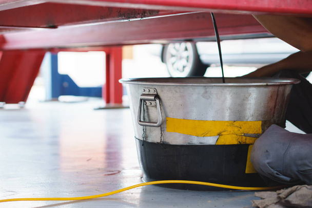 Steel bucket use for store old engine or mechanic oil from a car for change at an auto shop - Photo, Image
