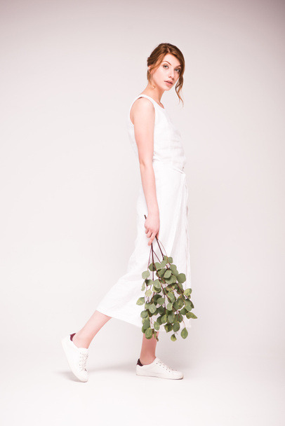 attractive woman with green branches - 写真・画像