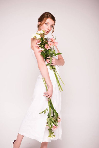 girl in white dress with flowers - Foto, Imagen