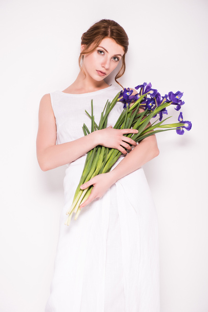 beautiful woman with iris flowers - Фото, изображение