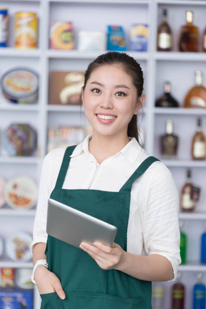 young pretty woman works in retail - Photo, image
