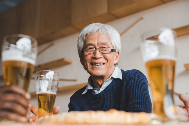 senior asian man in bar with friends - Photo, Image