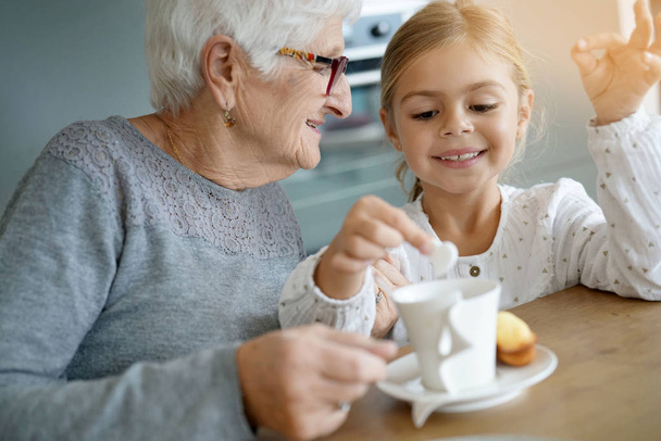 girl having tea time with grandma - Zdjęcie, obraz