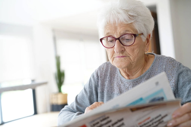 old woman reading newspaper - Photo, Image