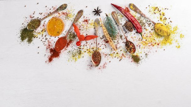 Spices and herbs. A large assortment of spices. Indian cuisine. On the wooden table. Top view. Free space for text. - Photo, Image