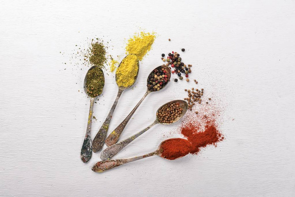 Spices and herbs. A large assortment of spices. Indian cuisine. On the wooden table. Top view. Free space for text. - Фото, изображение