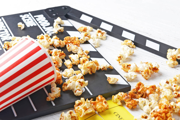 Caramel popcorn and movie clapper - Фото, зображення