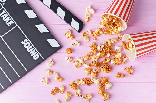 Caramel popcorn and movie clapper  - Fotografie, Obrázek