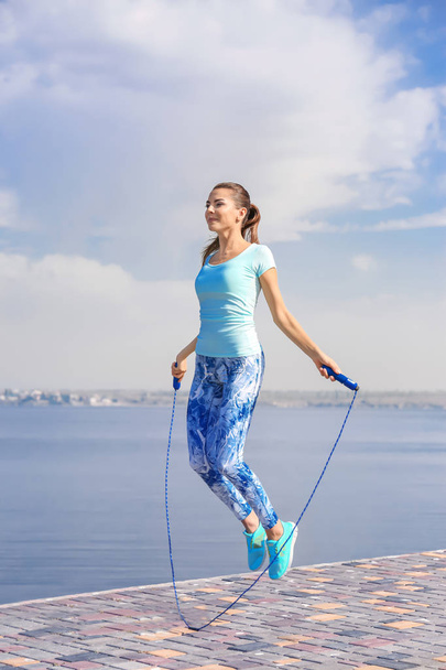Young woman with jumping rope - Fotoğraf, Görsel