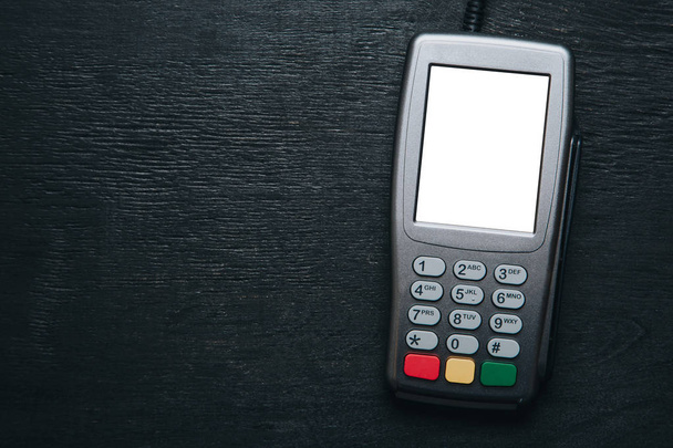 Credit card terminal on dark wooden desk - Photo, Image